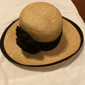 Straw hat with black flower bow and trim
